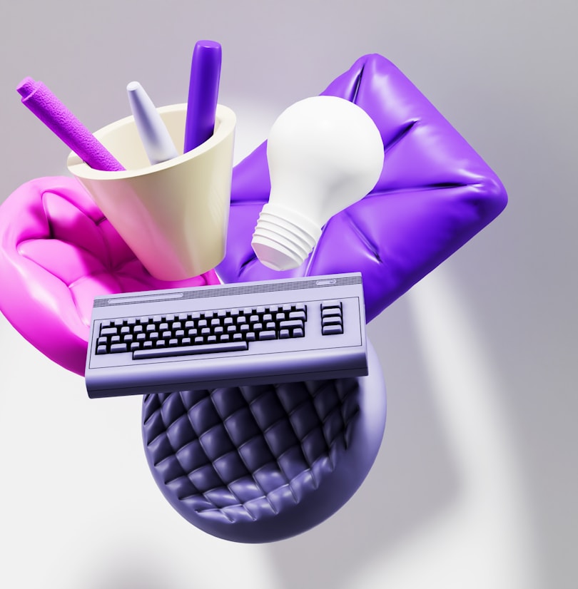 3D render of creative tools &mdash; a pen cup, idea lightbulb and keyboard &mdash; representing a creative and digital agency